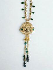 Gold orb potli bag with green gemstones and beaded chain handle on a white background, side view