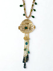 Gold orb potli bag with green gemstones and beaded chain handle on a white background, showing the clasp closure