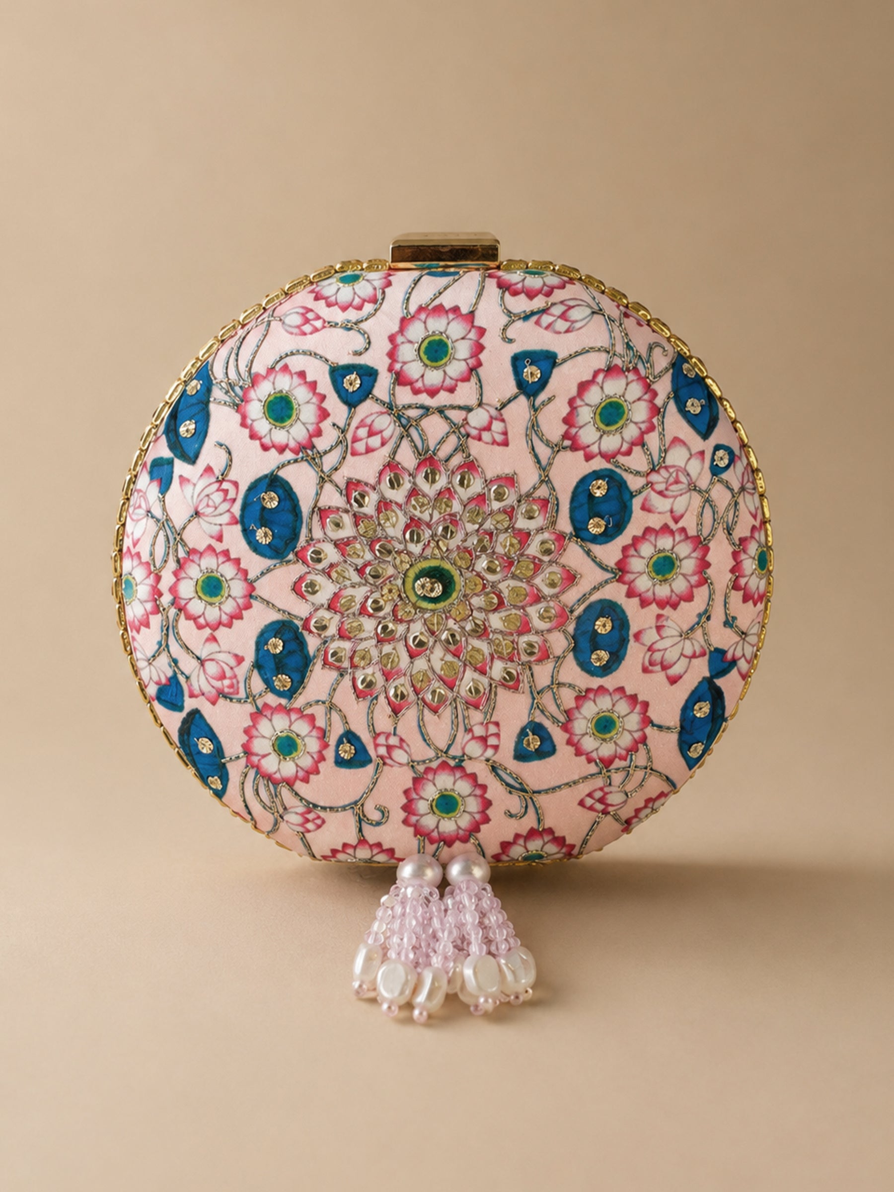 Kamal Bagh Embroidered Clutch, round pink clutch with a lotus mandala embroidery in pink and blue and beaded pearl tassels, front view