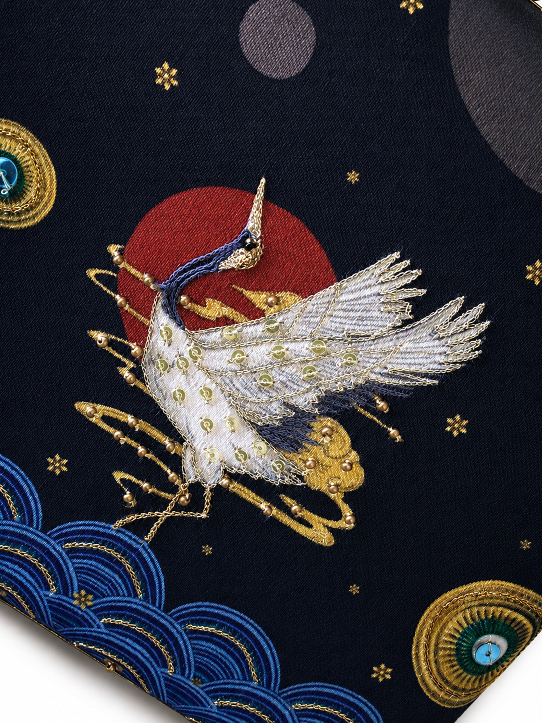 Angled view of the Midnight Crane Clutch's plain black back panel with its gold-trimmed frame and snake-shaped handle.