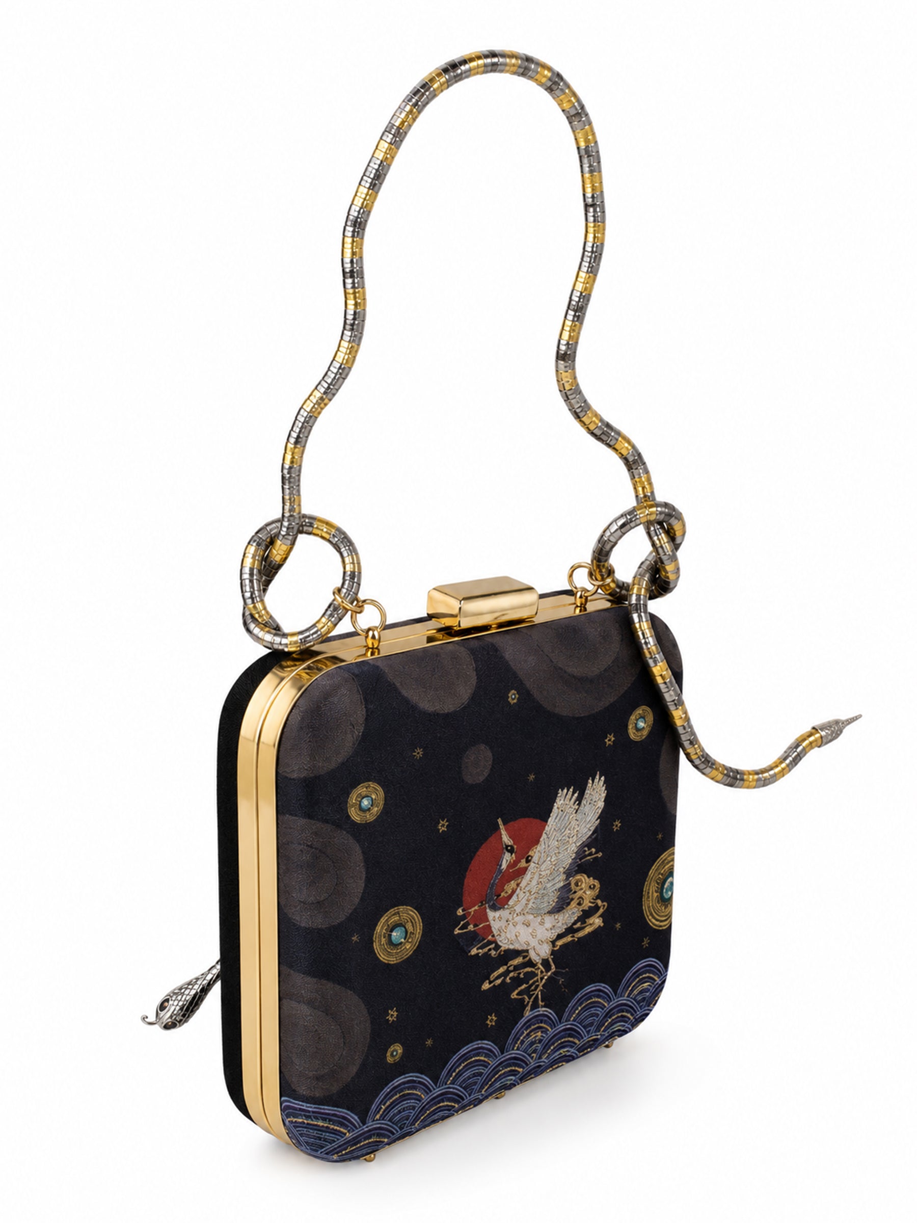 Angled view of the Midnight Crane Clutch showing the snake-shaped metallic handle and the embroidered crane and wave motif on the navy front panel.