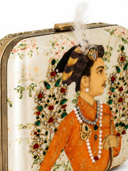 Close-up of the Shahjahan Clutch showing the detailed Mughal-style miniature portrait print of a nobleman in a jeweled turban with pearl necklaces, and the feather-topped clasp.