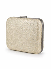 Angled side view of the Shahjahan Clutch showing the plain glittery gold back panel and metal frame.