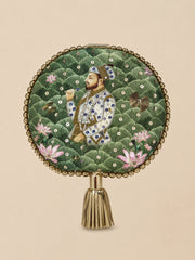 Mughal E Taj Embroidered Clutch, a round clutch in green scalloped fabric with a Mughal-style miniature portrait of a nobleman among lotus flowers, gold sequins, and a beaded border with gold tassel.