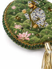 Close-up angled detail of the Mughal E Taj Embroidered Clutch showing the nobleman portrait, lotus flowers, emerald beaded edge, and gold tassel handle.