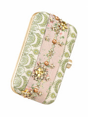 Angled side view of the Garden of Jewels Clasp Clutch showing the gold frame, green paisley-patterned fabric panel, and pink floral center band with pearl and crystal flower embellishments.