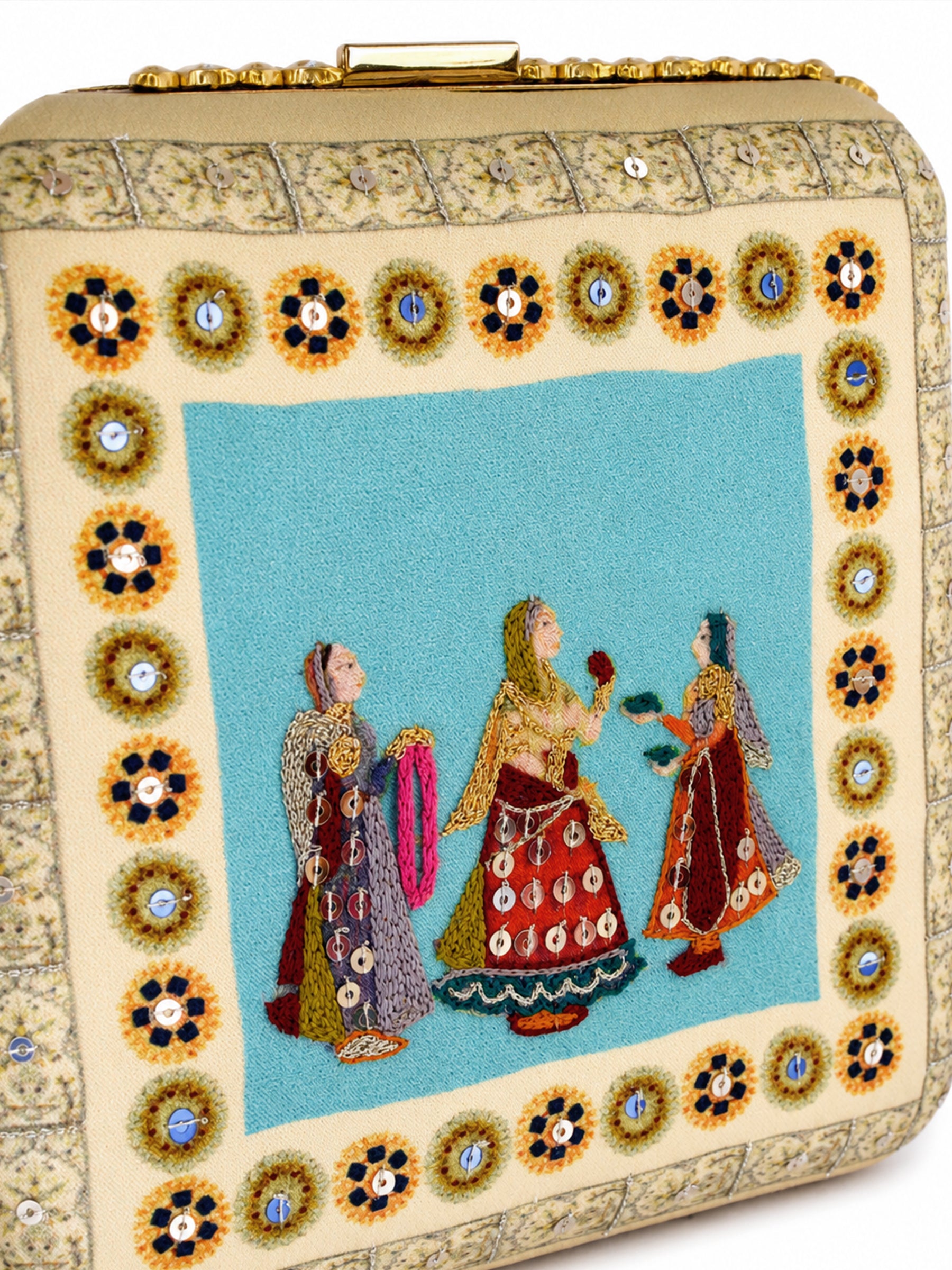 Close-up of the Saheliya Embroidered Clutch showing the gold beaded floral medallion border framing the turquoise hand-embroidered panel.