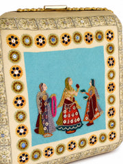 Close-up of the Saheliya Embroidered Clutch showing the gold beaded floral medallion border framing the turquoise hand-embroidered panel.