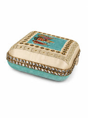 Front-angled view of the Saheliya Embroidered Clutch showing the cream embroidered top panel, turquoise velvet base, and crystal-studded gold trim.