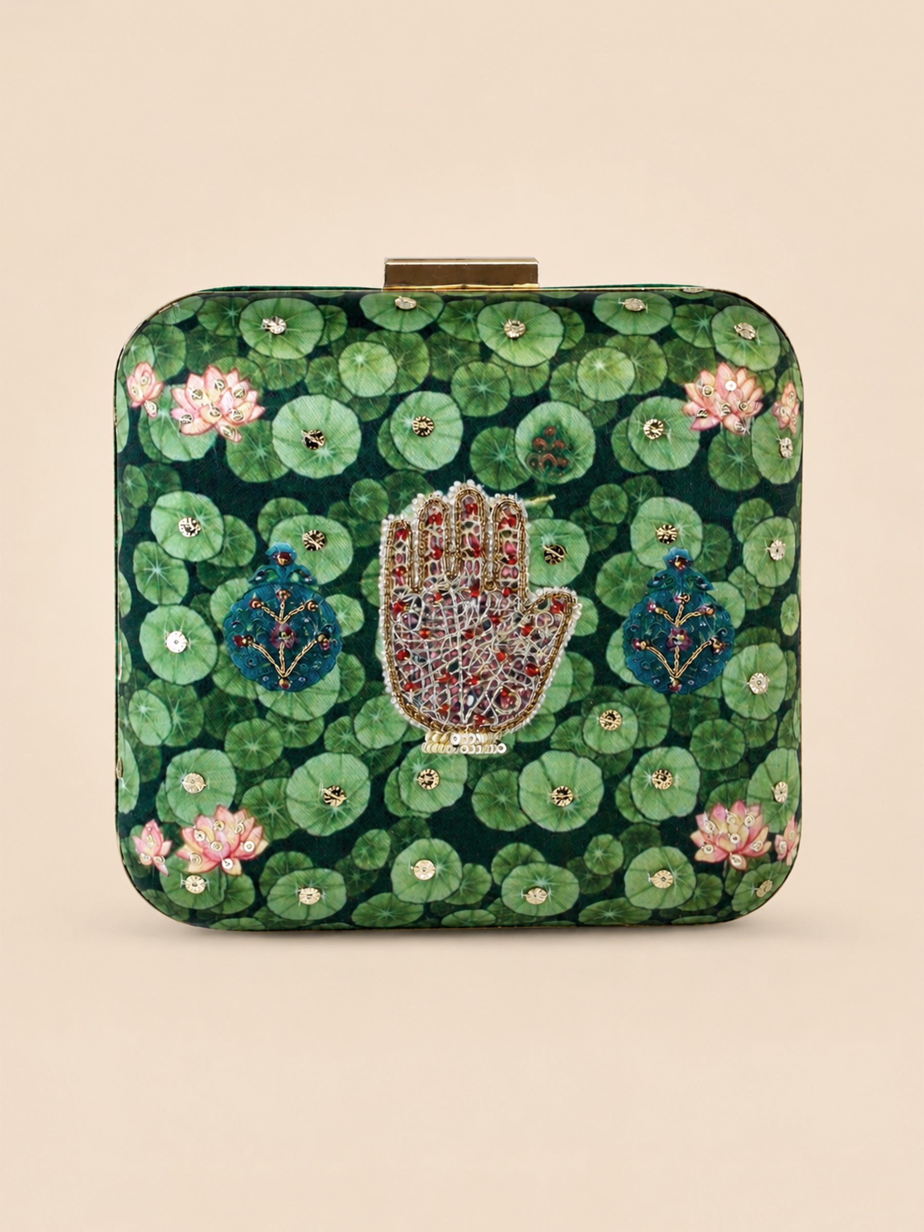 Hastkala Embroidered Clutch, a square box clutch in green fabric printed with lily pads and lotus flowers, centered with a beaded hand motif in gold, red, and white.