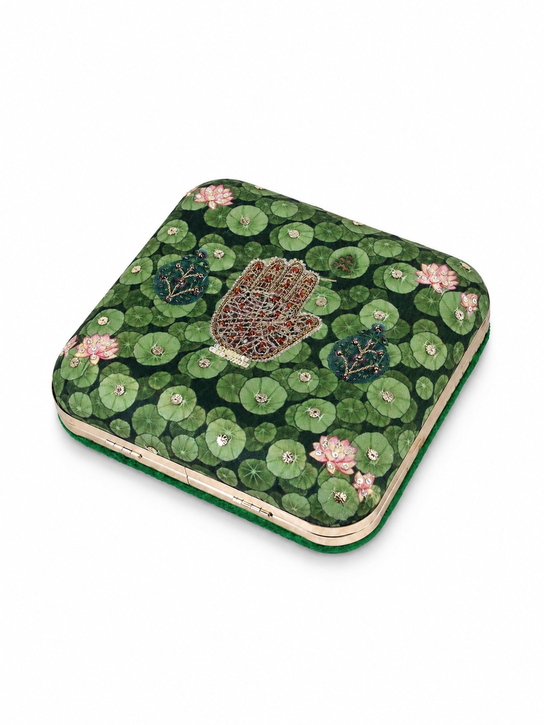 Angled top-down view of the Hastkala Embroidered Clutch showing the lily pad and lotus print with the beaded hand motif and gold clasp.